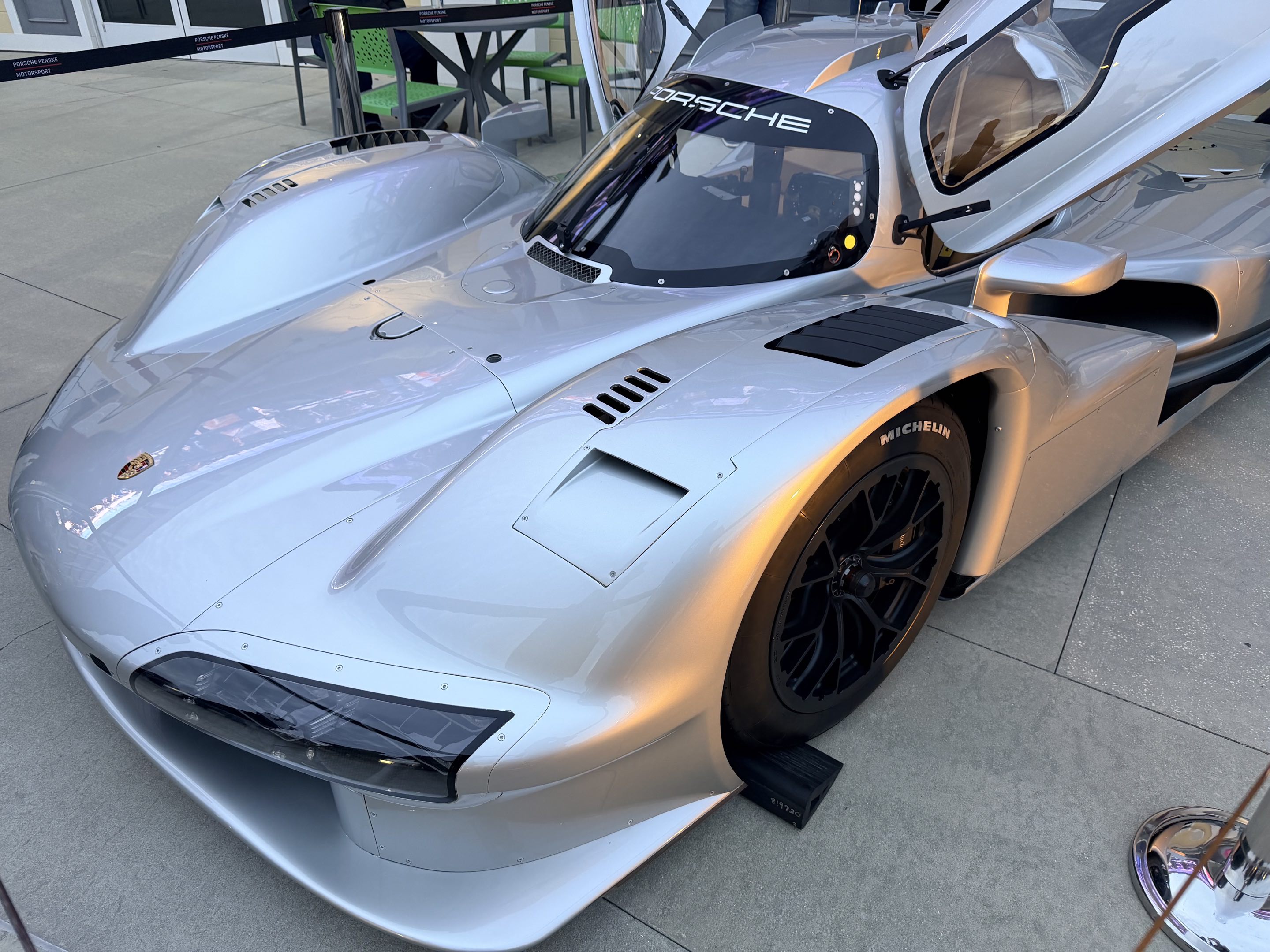 The front left corner of the Porsche 963 RSP parked at a fan event